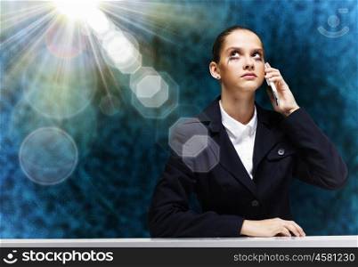 Troubled businesswoman. Young upset businesswoman talking on mobile phone