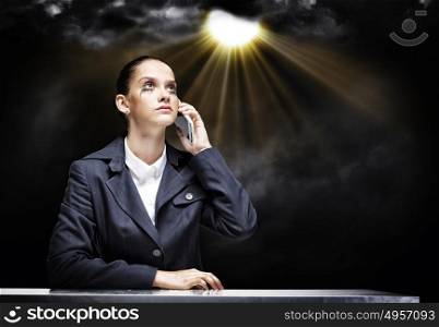 Troubled businesswoman. Young upset businesswoman talking on mobile phone