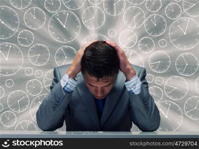 Troubles in business. Depressed tired businessman with hands on head