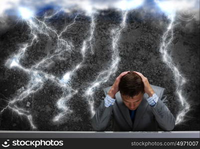 Troubles in business. Depressed tired businessman with hands on head