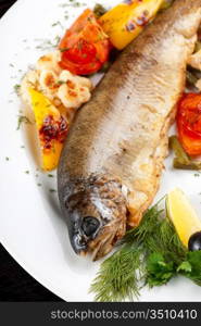 trout fish baked with pepper, string beans, tomato and cauliflower