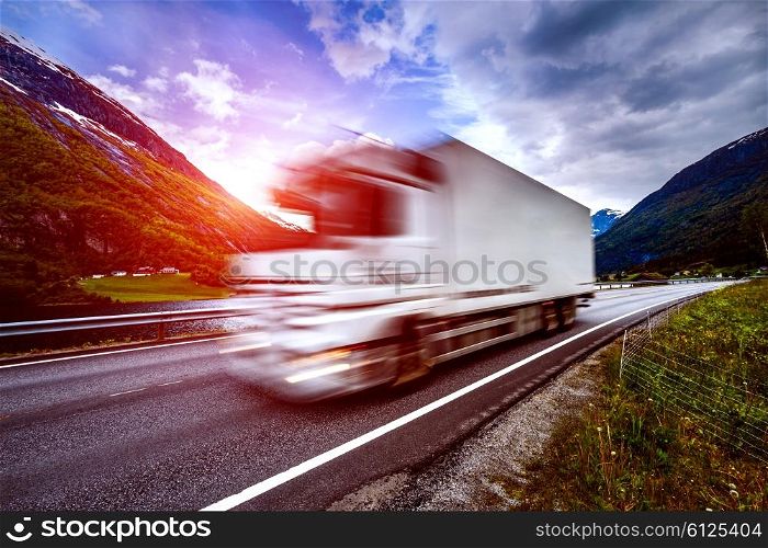 Truck and highway at sunset. Truck Car in motion blur.