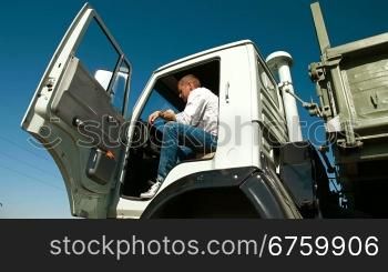 Truck Driver in Cab Using Mobile Phone