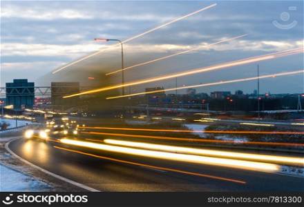 Truck passing by on a motorway junction on a winter evening