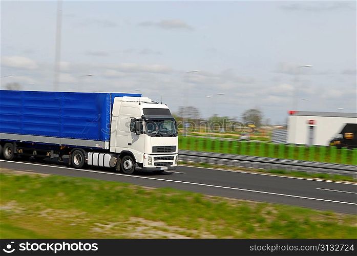 truck with freight moving fast