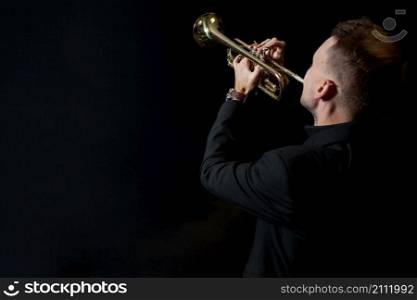 trumpet player black background