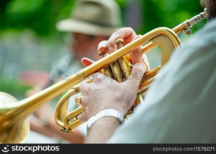 Trumpet player performs street performances with his group.