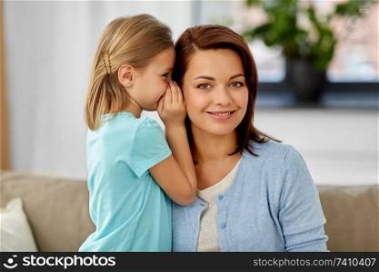 trust, gossiping and family concept - daughter whispering secret to mother at home. daughter whispering secret to mother at home