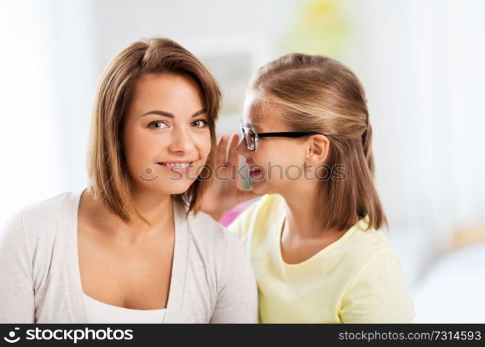 trust, gossiping and family concept - happy daughter whispering secret to her mother. happy daughter whispering secret to her mother