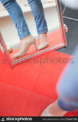 Trying on shoes in the mirror