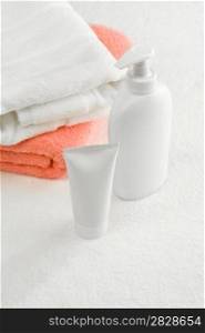 tube and spray bottle with towels