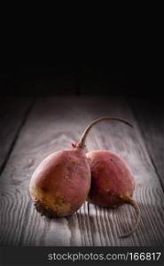Tuber beet on a wooden table. The concept of healthy food. Rustic.. Tuber beet on a wooden table