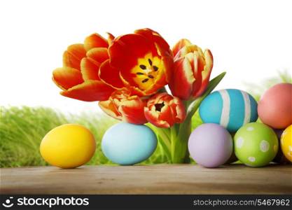 Tulips and easter eggs isolated on white background