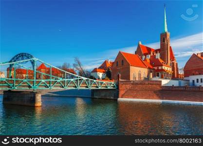 Tumski Bridge and Island with church of the Holy Cross and St. Bartholomew in the morning in Wroclaw, Poland