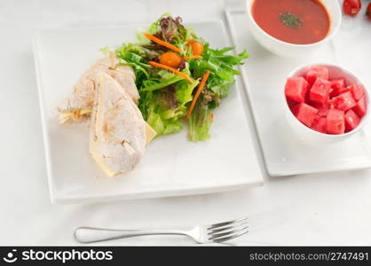 tuna fish and cheese sandwich with fresh mixed salad ,watermelon and gazpacho soup on side,with fresh vegetables on background ,MORE DELICIOUS FOOD ON PORTFOLIO