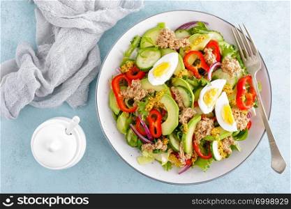 Tuna salad with boiled egg and fresh vegetables. Healthy diet food. Greek cuisine. Top view
