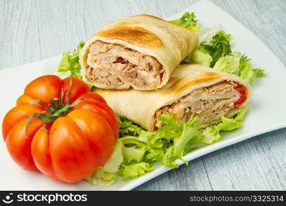 tuna sandwich on fresh salad and tomato