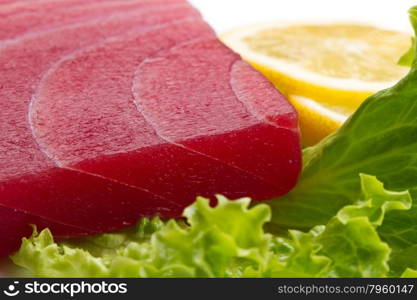 tuna sashimi with salad and lemon on white background