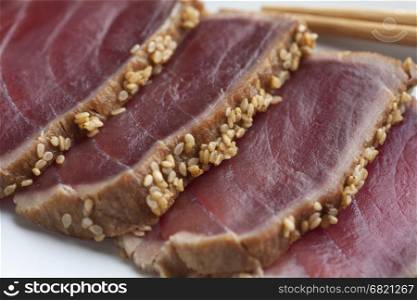 Tuna Tataki sashimi with sesame seeds close up
