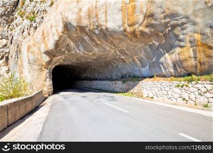 Tunnel carved in stone on mountain ridge near Omis view, dangerous roads of Croatia