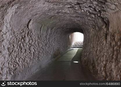 tunnel with walls made of stone. stone tunnel