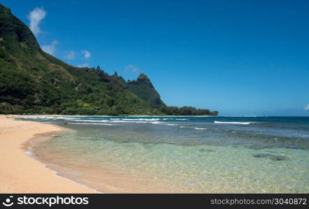 Tunnels beach on the north shore Kauai. View down the sand at Tunnels Beach in summer on Hawaiian island of Kauai on North Shore. Tunnels beach on the north shore Kauai