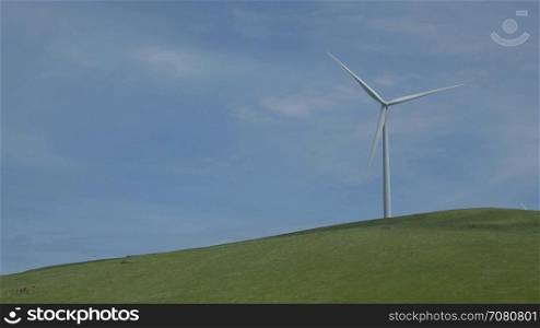 Turbine on a green hill in a Californian wind farm