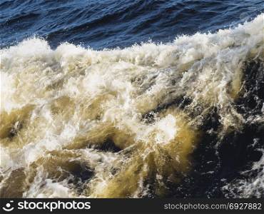Turbulent sea. With waves and white foam. Close-up