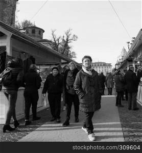 TURIN, ITALY - CIRCA DECEMBER 2018: People at Christmas market in black and white. Christmas market in Turin in black and white