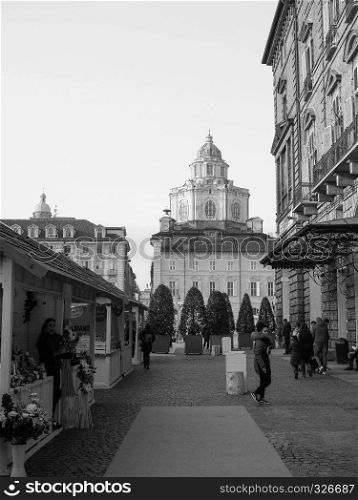 TURIN, ITALY - CIRCA DECEMBER 2018: People at Christmas market in black and white. Christmas market in Turin in black and white