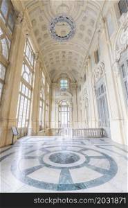TURIN, ITALY - CIRCA JUNE 2021: The most beautiful Baroque hall of Europe located in Madama Palace (Palazzo Madama). Interior with luxury marbles, windows and corridors.