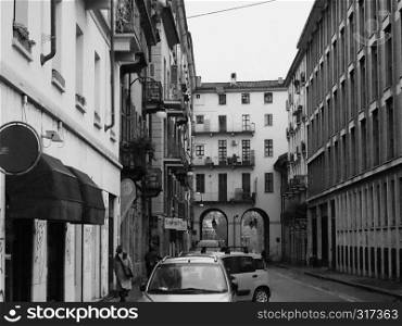 TURIN, ITALY - CIRCA NOVEMBER 2018: People in the city centre in a rainy day in black and white. People in Turin city centre in black and white