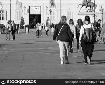 TURIN, ITALY - CIRCA OCTOBER 2018: People in Piazza Castello square in black and white. Piazza Castello square in Turin in black and white