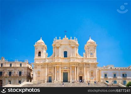 Turists in front of the most important baroque cathedral of Sicily, San NicolA?, Unesco Heritage site, sunny day