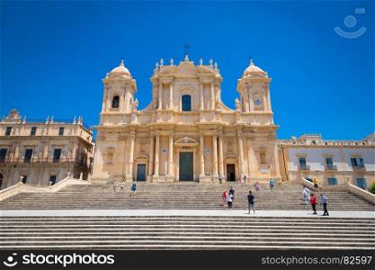 Turists in front of the most important baroque cathedral of Sicily, San NicolA?, Unesco Heritage site, sunny day