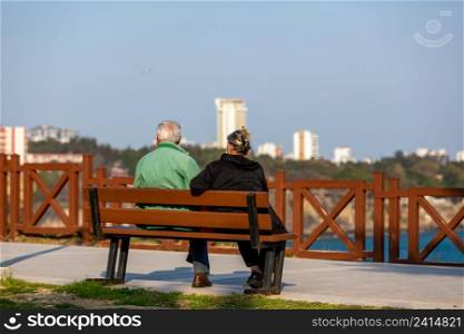Turkey - Antalya Elderly couple sitting on a bench by the sea.People watching the scenery by the sea.