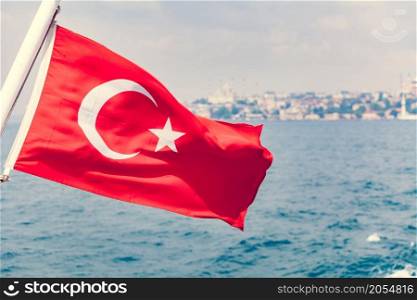 Turkey flag waving over blue sky and sea background. Turkey flag waving