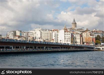 Turkey, Istanbul. A view of the Galata Bridge and the Galata Tower and a beautiful cloudy sky. A view of the Galata Bridge and the Galata Tower