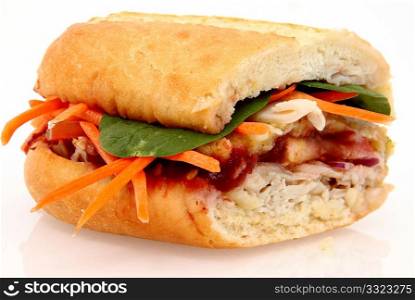 Turkey meat, dressing, cranberry sauce, carrots, spinach on a sub bun.