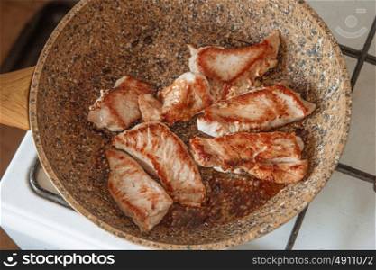 Turkey steak frying on pan above view