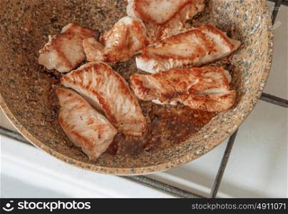 Turkey steak frying on pan top view