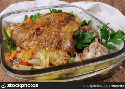 Turkey thigh baked with vegetables in a pan