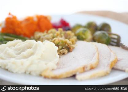 Turkey with stuffing, mashed potatoes, brussels sprouts, sweet potatoes and cranberry sauce
