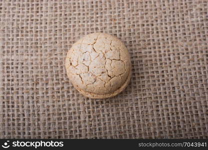 Turkish almond cookie in hand on a linen canvas