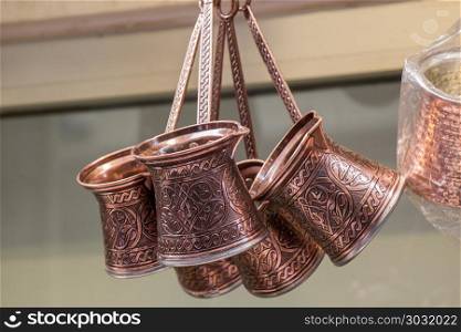 Turkish coffee pots made of metal in a traditional style. Turkish coffee pots made of metal in a traditional style
