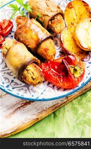 Turkish cuisine, meat fingers in eggplant rolls. Turkish dish of eggplant parmak-koft