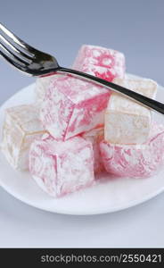 Turkish delight (lokum) confection on a white dessert plate