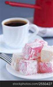 Turkish delight (lokum) confection with black coffee and traditional coffee pot