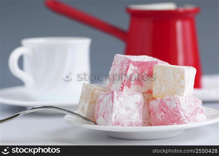 Turkish delight (lokum) confection with traditional coffee pot