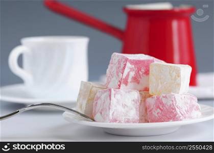 Turkish delight (lokum) confection with traditional coffee pot